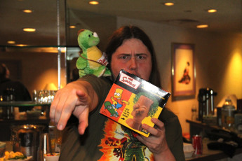 Trevor Bone (our audio engineer) with our deflamed baby dragon and Bart Simpson Chia Pet.